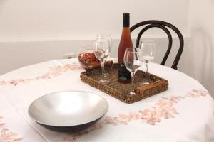a table with two glasses and a bottle of wine at Apartments Andrea in Šibenik