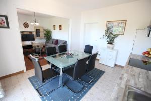 a dining room and living room with a table and chairs at Apartment Marin in Donji Seget