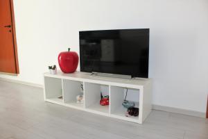 a white entertainment center with a flat screen tv at Casa 1941 in Conversano