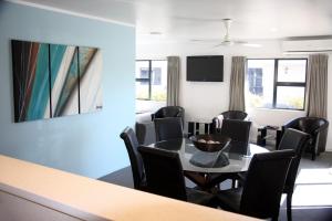 a meeting room with a table and chairs at Camelot On Ulster in Hamilton