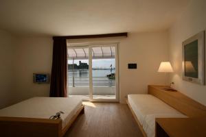 Voodi või voodid majutusasutuse Piccolo Hotel Del Lido toas