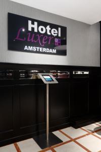 a hotel room with a sign on the wall at Hotel Luxer in Amsterdam