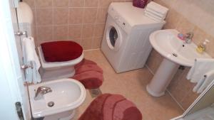 a small bathroom with a toilet and a sink at Rooms Kvestic in Dubrovnik