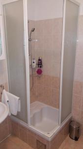 a shower stall in a bathroom with a tub at Rooms Kvestic in Dubrovnik