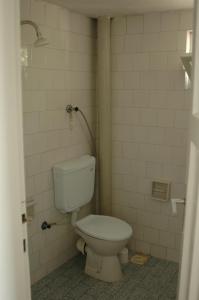 a bathroom with a white toilet in a room at Kiyak Hotel in Demre