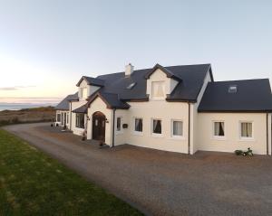 a large white house with black roof at Atlantic Breeze in Rossnowlagh