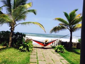 a hammock hanging from two palm trees on a beach at Casa Playa San Diego in San Diego