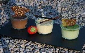 a black tray with three different types of desserts at Hotel Zur Post in Roßbach