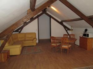 a living room with a couch and a table at La Ferme de la Petite Noé in Tracy-sur-Mer