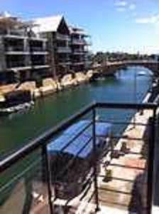 a balcony with a view of a body of water at Huge House on the Grand Canal in Mandurah