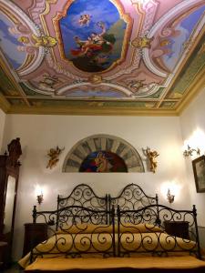 een slaapkamer met een bed met schilderijen aan het plafond bij Old Taverna Sorrentina in Sorrento