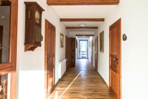 a hallway with wooden floors and wooden doors at Hotel Waldhäusel in Bad Schandau