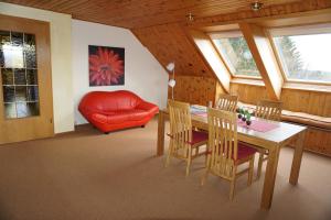 a living room with a table and chairs and a couch at Ferienwohnung Hoher Weg in Clausthal-Zellerfeld