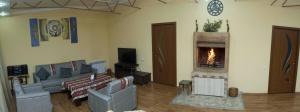 a living room with a couch and a fireplace at Yerevan-Sky with terrace in Yerevan