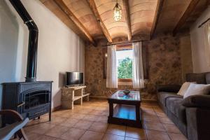 a living room with a couch and a fireplace at Agroturisme Son Llado in Campos