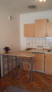 a kitchen with a table and a counter top at Guest House Potok in Lokve
