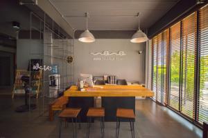 a dining room with a large wooden table and chairs at Wara Boutique Hotel in Udon Thani