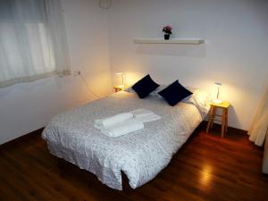 a bedroom with a bed with white sheets and pillows at Loft in the heart of Córdoba by gms apartamentos in Córdoba