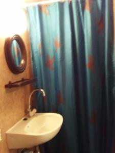 a bathroom with a sink and a shower curtain with fish at Magdaléna Vendégház in Bük +18 photos