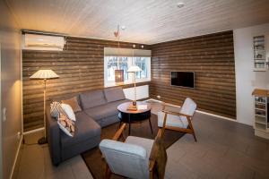 a living room with a couch and a table at Soukolo Apartments in Äkäslompolo