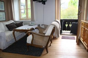 a living room with a couch and chairs and a fireplace at Gästehaus Nicole in Garmisch-Partenkirchen