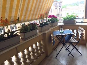 a balcony with a table and potted plants on it at Milizie 76 Gallery in Rome