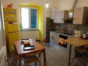 a kitchen with a wooden table and a dining room at B&B Al Fronte del Porto in Genova +25 photos