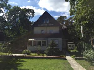 a black and white house with a sign on it at Haus Sonnenschein in Boltenhagen