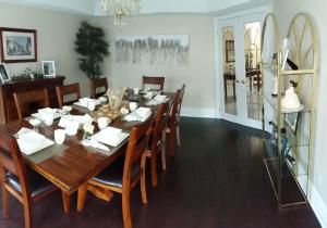 a dining room with a wooden table and chairs at Molly's Retreat B and B in Orangeville