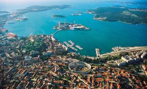 an aerial view of a city with a large body of water at Luka in Pula