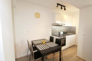 a small kitchen with a table and a stove at Rabac 1 in Rabac