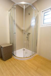 a shower with a glass enclosure in a room at Casa do Mar in Ribeira Grande