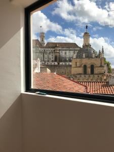 a view of a city from a window of a building at Casa da Sé Cathedral Suites in Coimbra