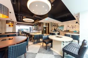 a dining room with tables and chairs in a restaurant at P&E Hotel in Tainan