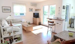 a living room with a couch and a table at Apartman Castil in Bol