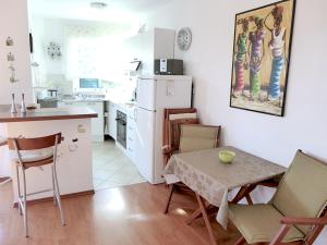 a kitchen with a table and chairs and a small kitchen with a table at Tia Maria in Bol