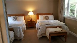 a hotel room with two beds and two lamps at Starlight Lodge Cape Cod in Dennis
