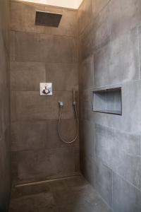 a bathroom with a shower with a hose at Guesthouse Altes Rathaus in Rüdesheim am Rhein
