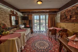 a restaurant with tables and chairs in a room at Penzion Havran in Ždiar +136 photos