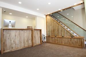 a large room with wooden doors and a staircase at The Ormonde Guesthouse in Chester