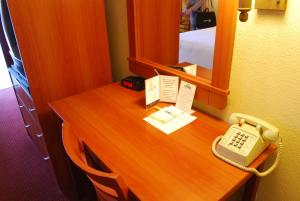 a desk with a phone and a keyboard on it at Days Inn by Wyndham Las Vegas Wild Wild West Gambling Hall in Las Vegas