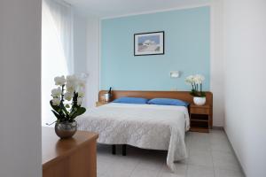 Postel nebo postele na pokoji v ubytování Hotel Emilia