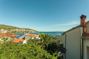 a view of a town with the ocean in the background at Villa Aequum in Trogir