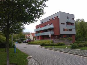 a building on a street next to a road at Apartmán blizko centra Prahy in Prague