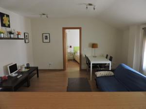 a living room with a blue couch and a table at Apartamento El Rasero in Riaza