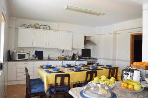 a kitchen with a table with blue dishes on it at Apartment Peniche swimming pool in Peniche de Cima
