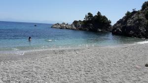 a person swimming in the water on a beach at Kalithea Studios in Stafylos