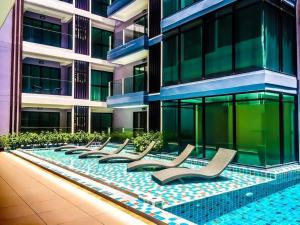 a row of chairs in front of a building at Tropical Garden Studio in Pattaya South