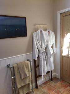 a room with white towels hanging on a rack at Ivy Cottage in Laxton