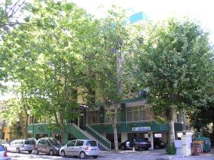 a building with cars parked in front of it at Hotel Bellevue in Cesenatico